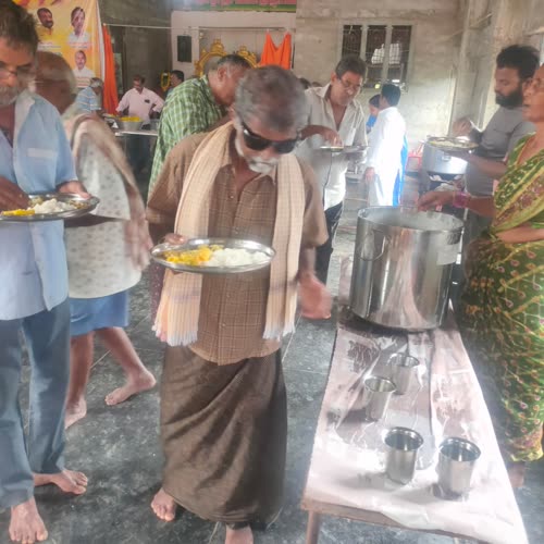 A man carrying his plate of food away from the counter