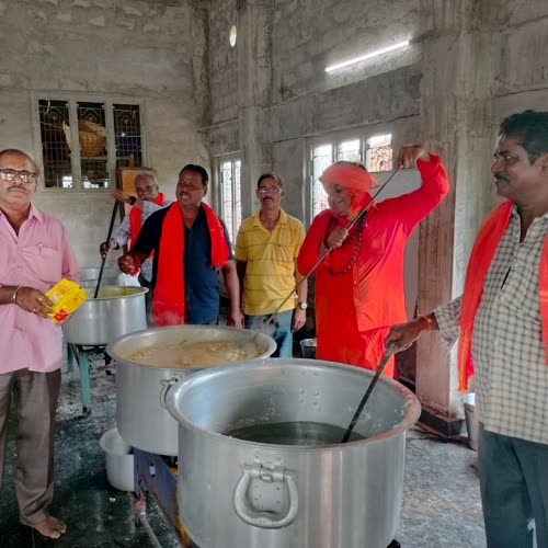 Volunteers beside the large cooking vessels