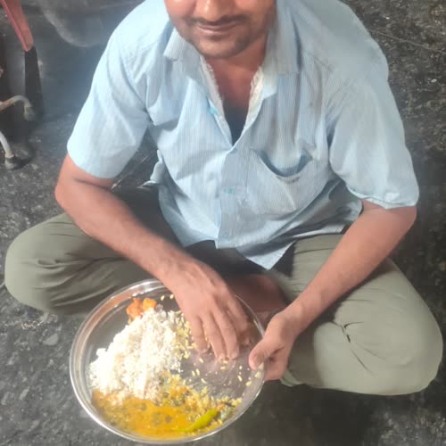 A man smiling over his full plate